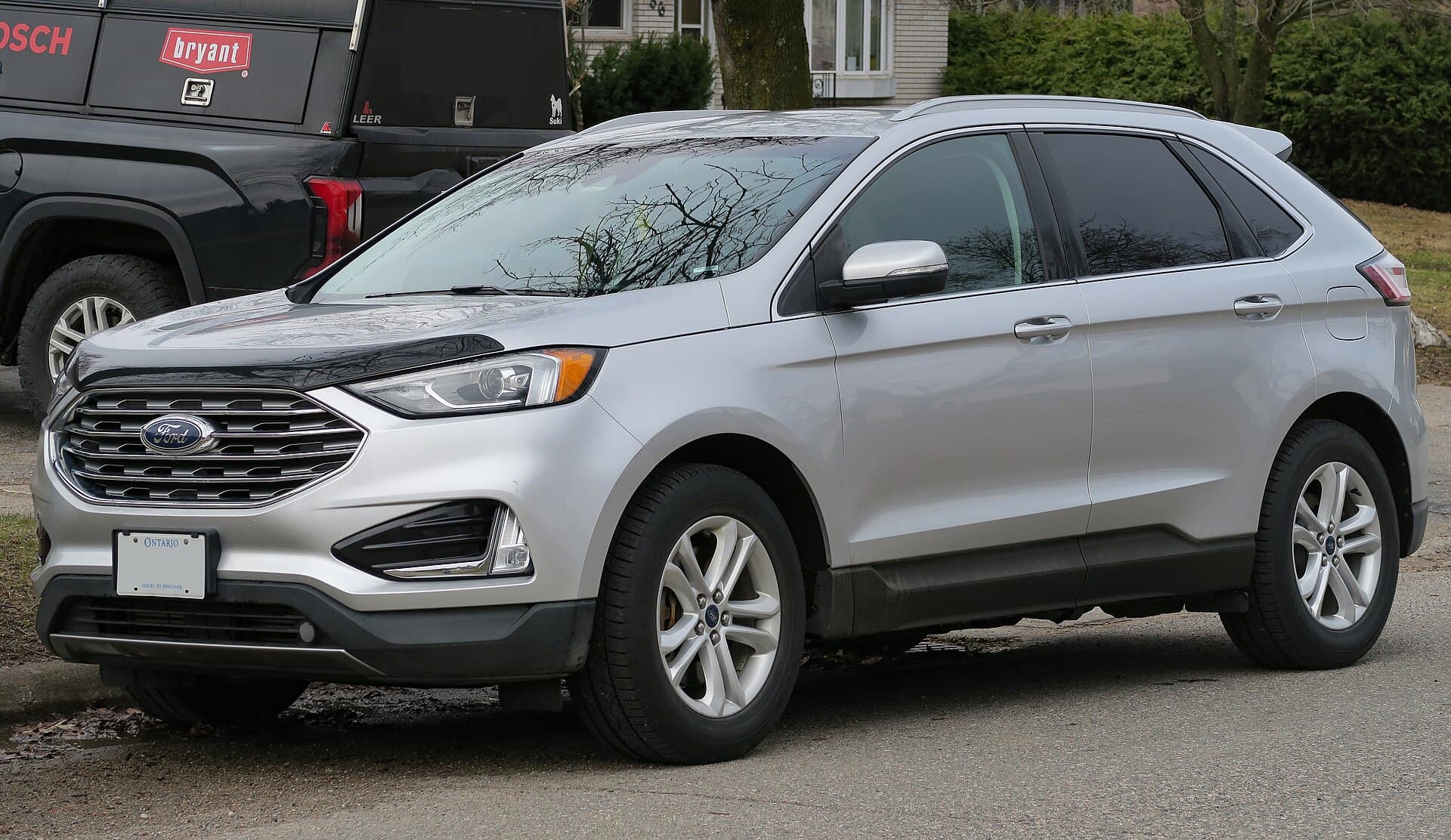 Silver Ford Edge SEL crossover parked on a residential street